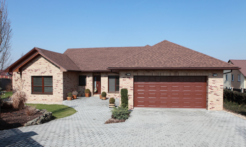 Red stone home and glass garage door