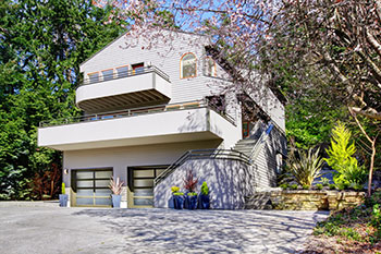 Red stone home and glass garage door